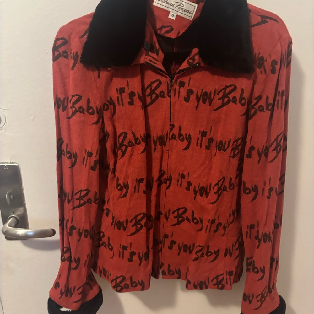 Vibrant Red Jacket with Black Text by